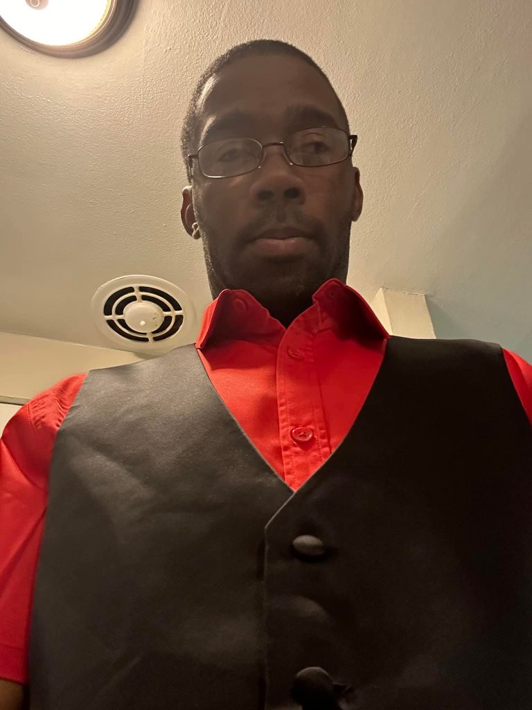 Man in red shirt and vest
