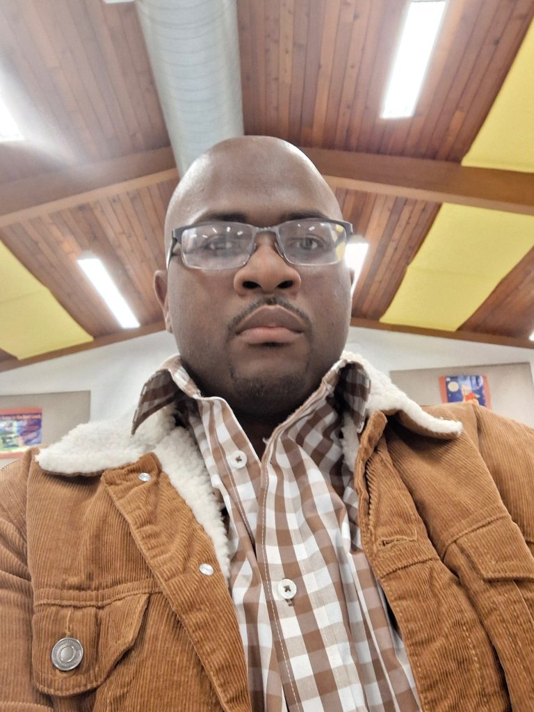 Person in glasses and checkered shirt